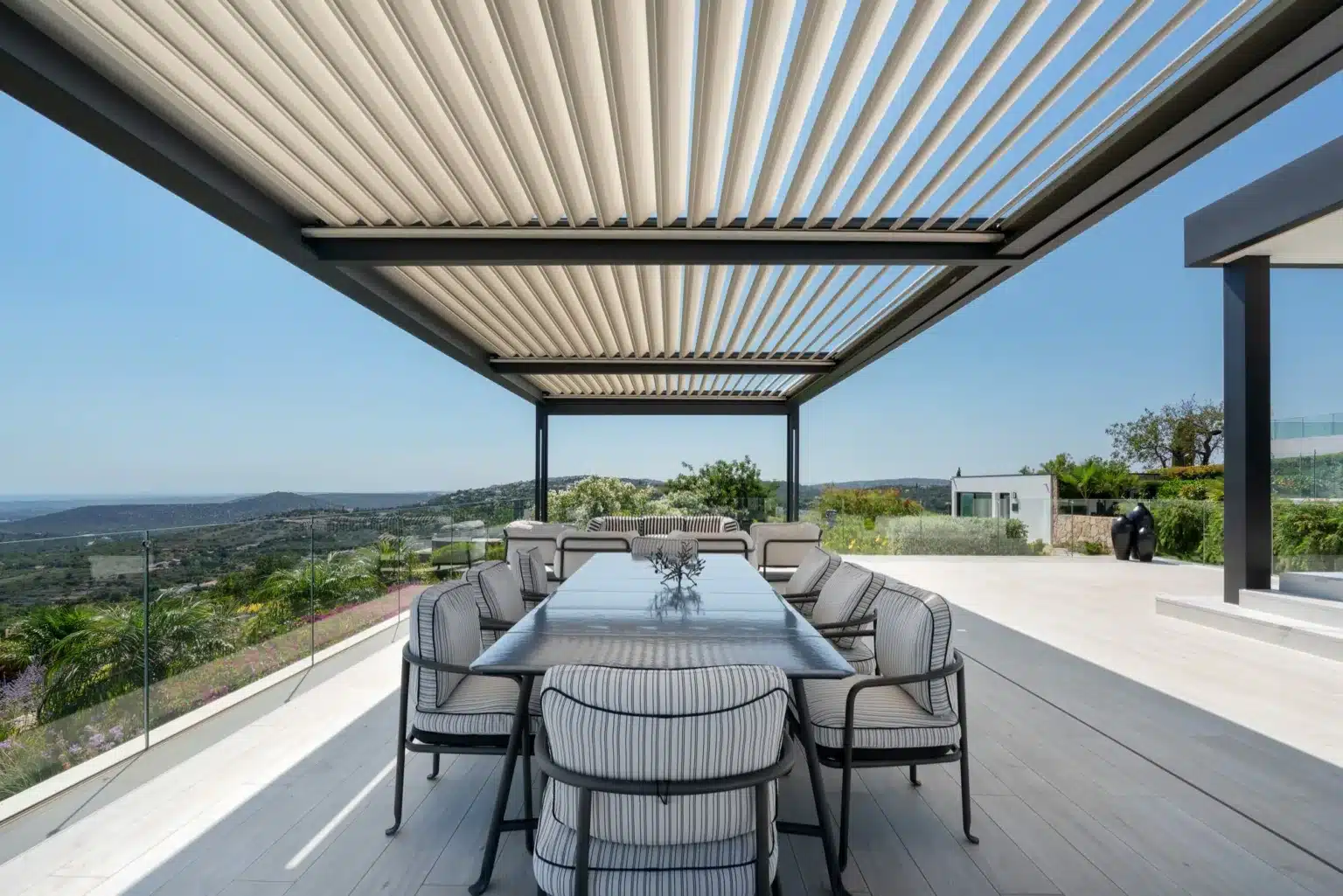 Dining table under a Solembra pergola with sea view, Algarve